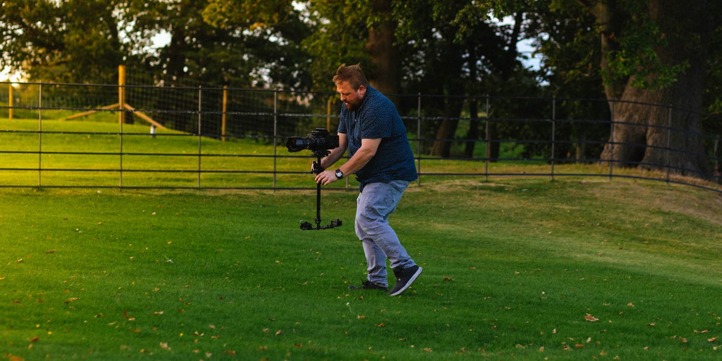 Chris filming a wedding with professional camera equipment